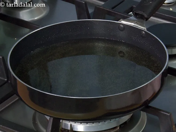 Step 21 – Heat the ghee in a broad non-stick pan to fry the <strong>crispy homemade jalebi</strong>. Using …