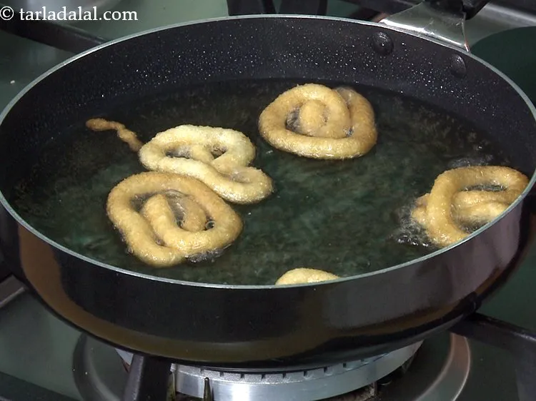 Step 24 – Turn them with a pair of flat tongs and deep-fry till the jalebis turn golden …