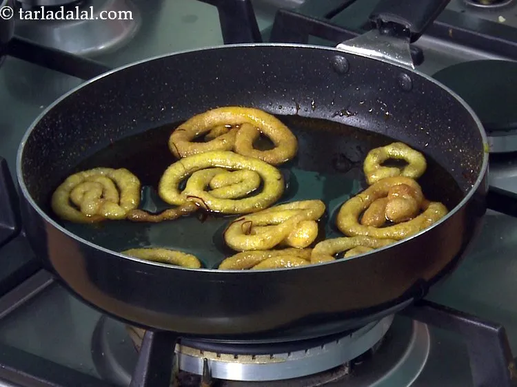 Step 31 – Do not leave the jalebi in the sugar syrup for too long to avoid it …