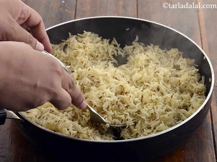 Step 18 – Separate each grain of rice lightly with a fork.