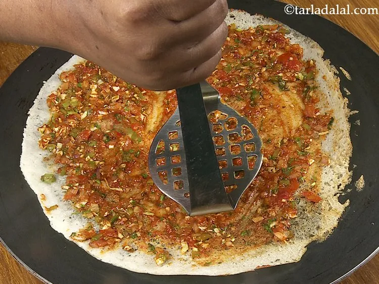 Step 24 – Mix well using a flat ladle and and spread the mixture on the entire dosa. …