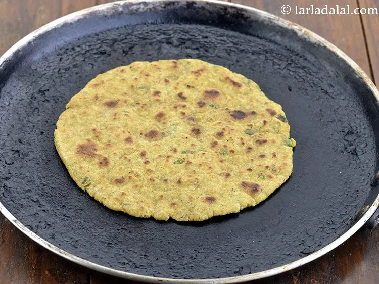 Step 17 – Heat a non-stick tava (griddle) and cook the Indian style millet onion roti, using &frac12; …