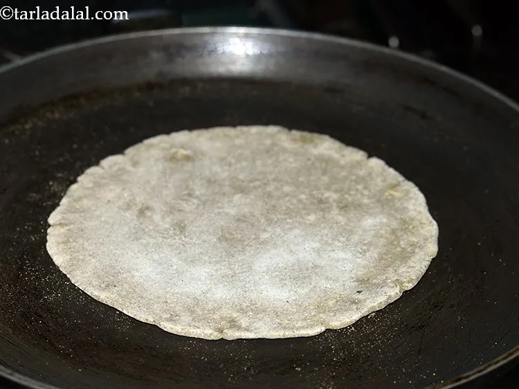 Step 12 – Turn over the roti and cook the other side for a few more seconds.