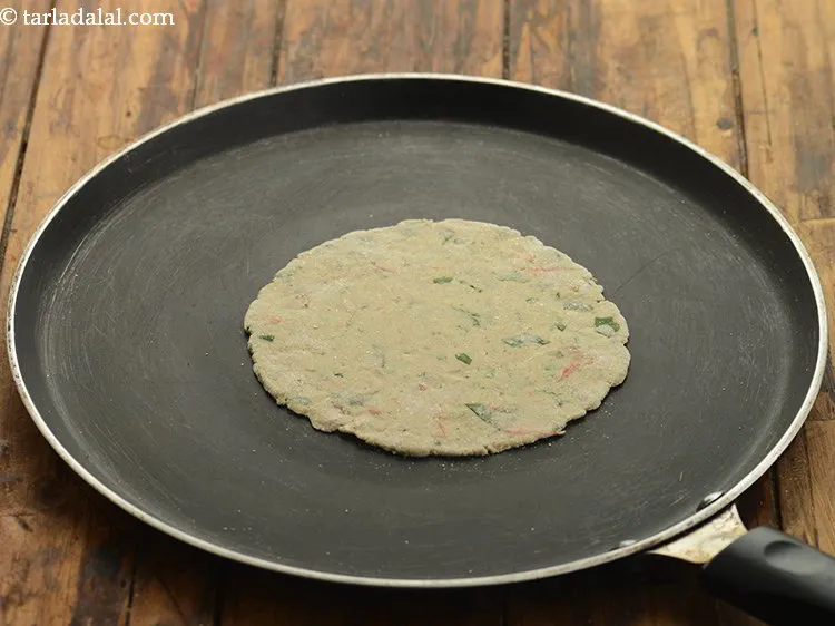 Step 19 – Heat a non-stick tava and place the rolled&nbsp;<strong>multigrain vegetable roti for kids&nbsp;</strong>on it.