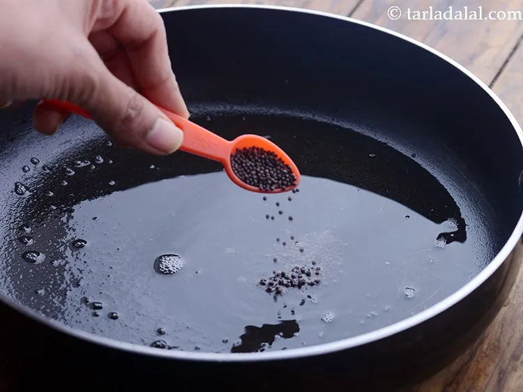 Step 5 – Once the oil is hot, add the mustard seeds.