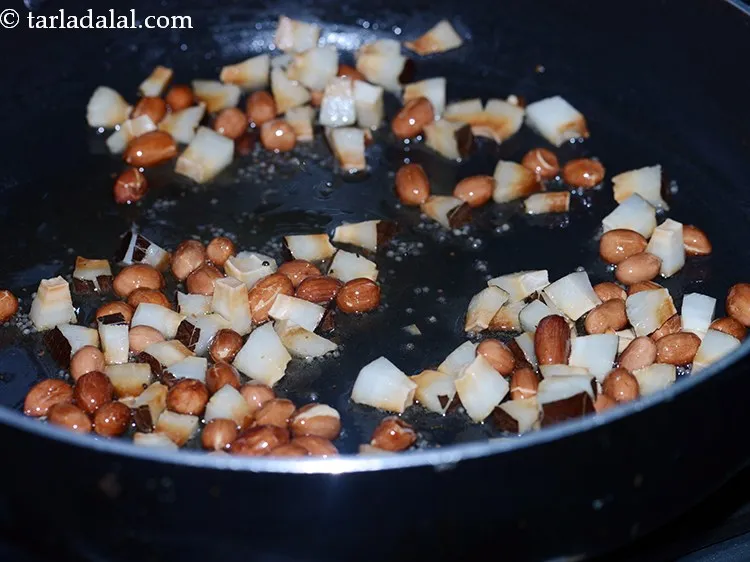 Step 8 – Add the coconut. Also, you can add peanuts, cashew nuts, raisins, almonds to make <strong>Jowar …
