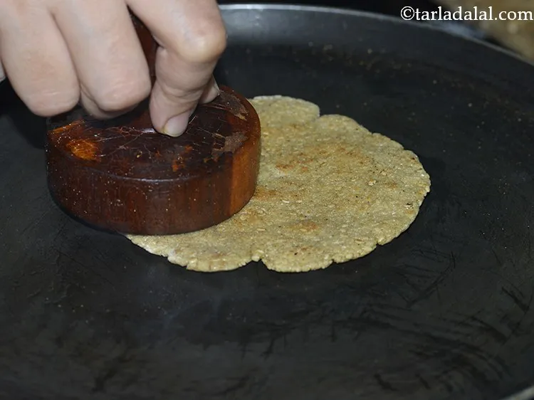 Step 20 – Keep pressing the khakhra with a &lsquo;khakhra press&rsquo; continuously while flipping it every 30 seconds …