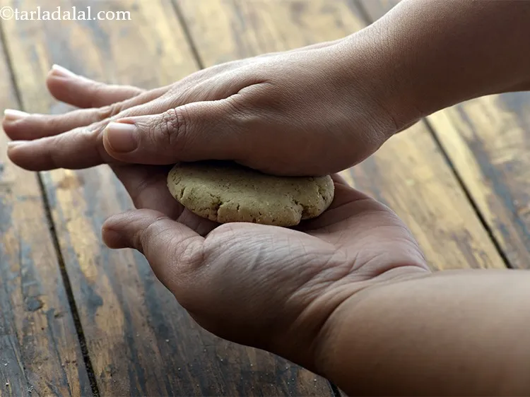 Step 14 – Meanwhile take a portion of the dough and roll it well in between your palms …