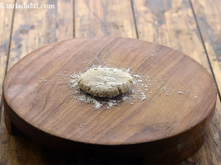 Step 15 – Place it on a rolling board and sprinkle some jowar flour on it.&nbsp;
