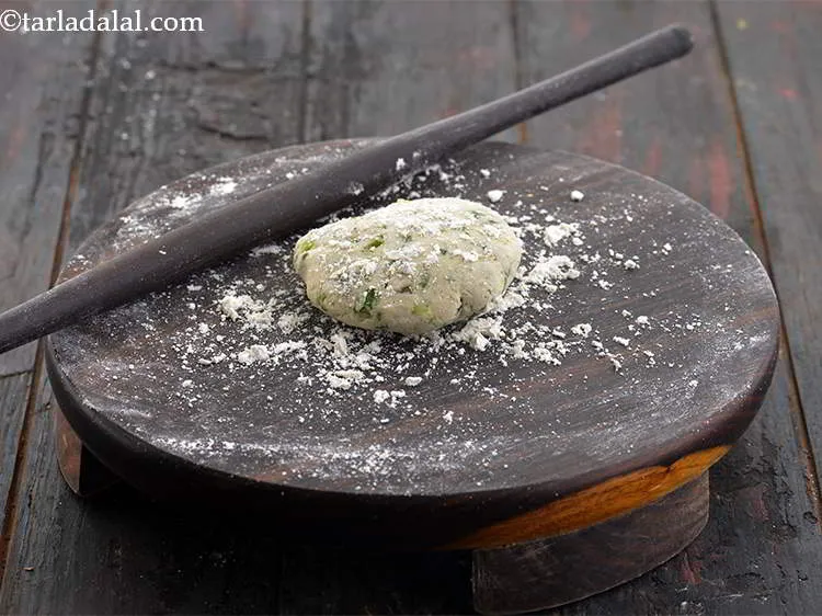 Step 15 – Sprinkle some good amount of dry jowar flour on the rolling board and flatten a …