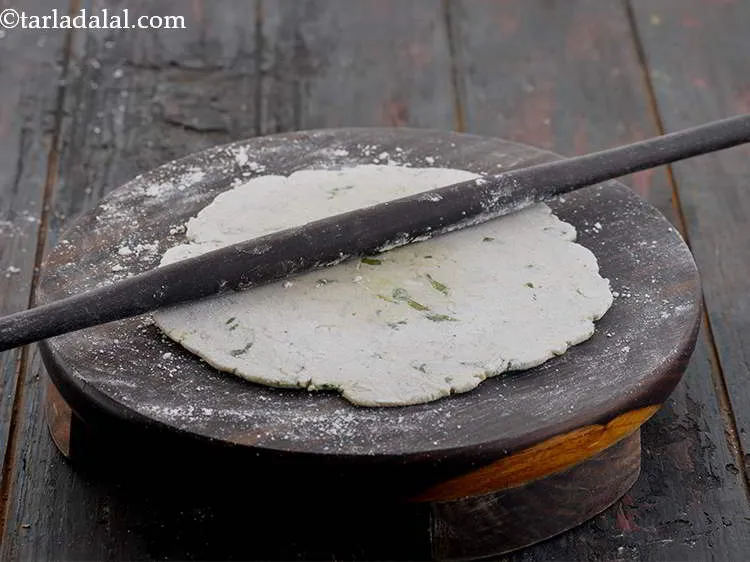 Step 16 – Roll it into 150 mm. (6&quot;) diameter circle using a rolling pin. Use more jowar …