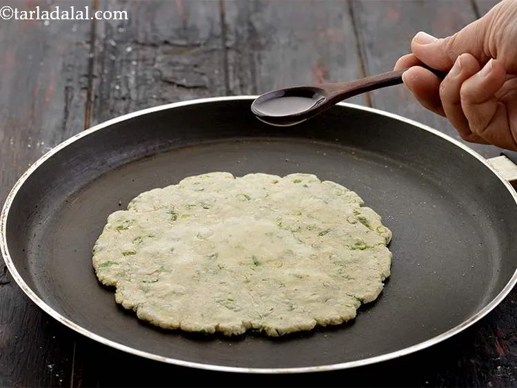 Step 18 – Cook it on a medium flame using &frac14; tsp of <a href="https://www.tarladalal.com/glossary-oil-671i">oil</a>&nbsp;for cooking&nbsp;each roti.