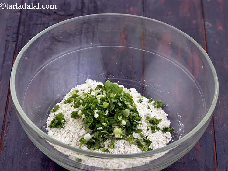 Step 4 – Add 1/2 cup&nbsp;finely&nbsp;<a href="https://www.tarladalal.com/glossary-chopped-spring-onion-whites-815i">chopped spring onions whites</a>&nbsp;and&nbsp;<a href="https://www.tarladalal.com/glossary-chopped-spring-onion-greens-1030i">greens</a> to it. Use spring onions whites and …
