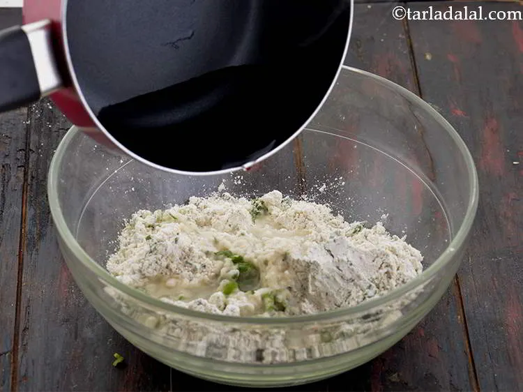 Step 10 – Carefully pour the hot water in the bowl of jowar flour mixture. Hot water is …