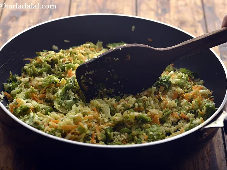 Step 23 – Mix all the ingredients very well using a flat ladle.Again cook it on a medium …