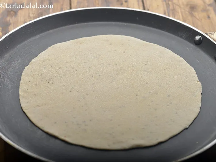 Step 10 – Heat a non-stick tava (griddle) and place the rolled roti on it. Allow it cook …