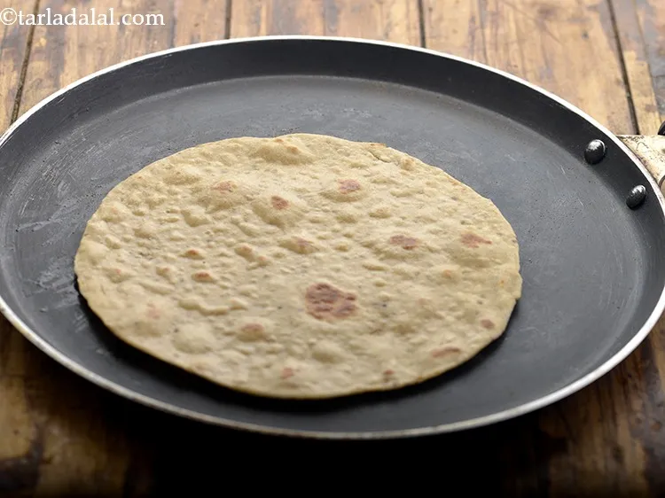 Step 25 – Just before serving, heat a non-stick tava (griddle), place a jowar roti on it and …