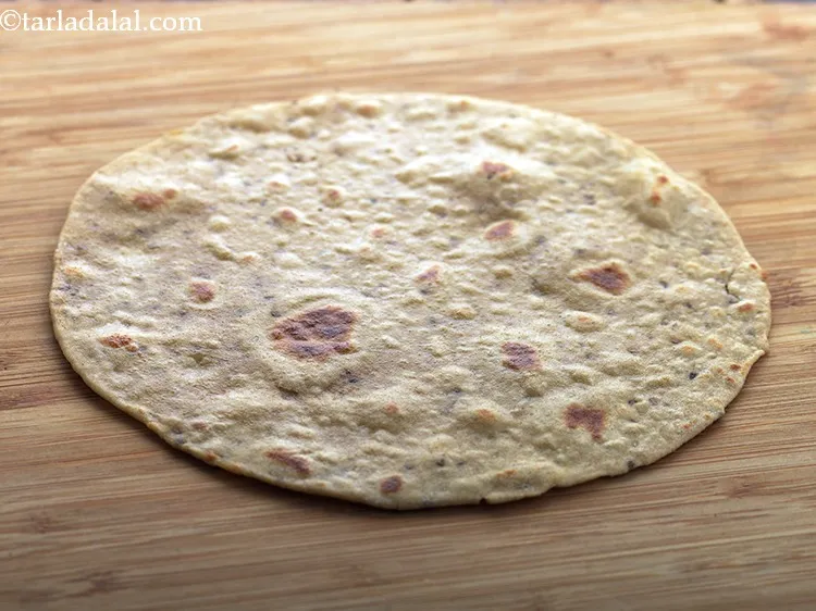 Step 26 – Remove the Jowar Roti from the tava and place it on a clean flat surface.