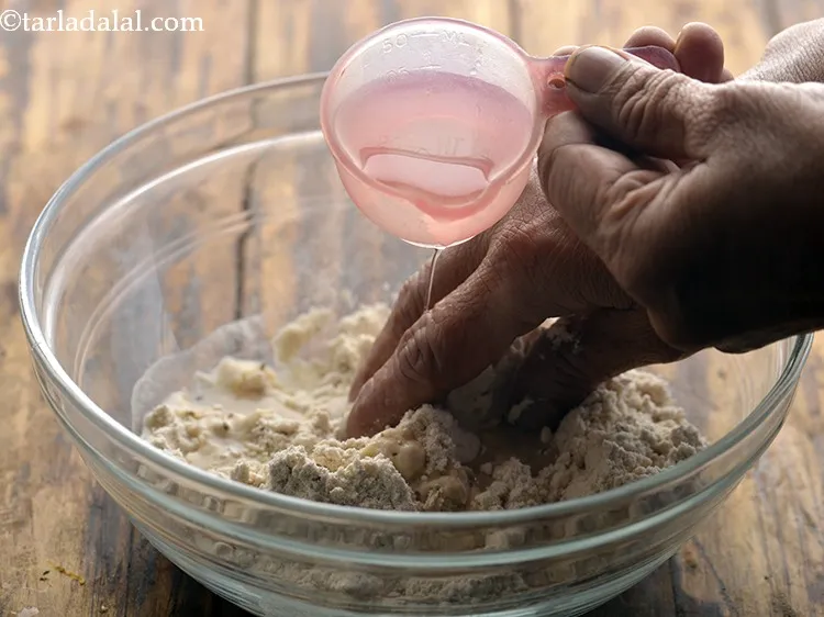 Step 7 – Add enough water and knead into a soft dough. Keep the <strong>Jowar Roti dough</strong> aside …