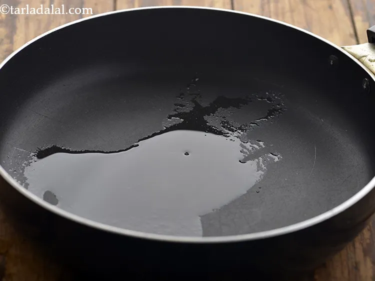 Step 14 – For the <strong>Veggie Stuffing of Jowar Veggie Wrap</strong>, take a broad non-stick pan. Add peanut …