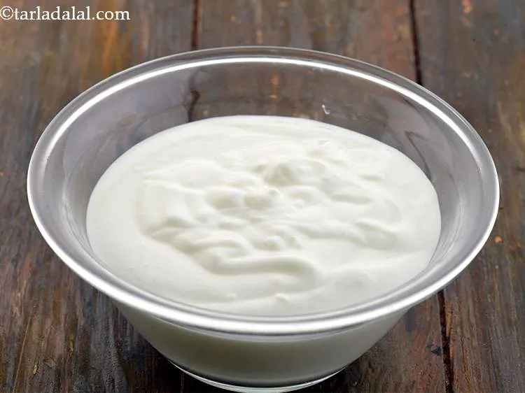 Step 16 – Take a bowl and add the curd into it.&nbsp;Whisk it well till it becomes smooth.