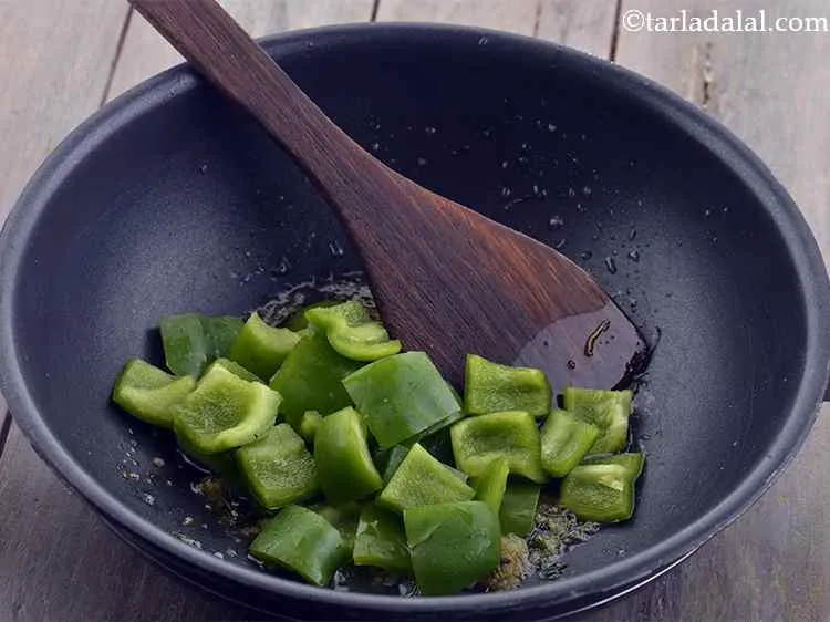 Step 8 – Add the capsicum. We have used green coloured capsicum but if you wish you can …