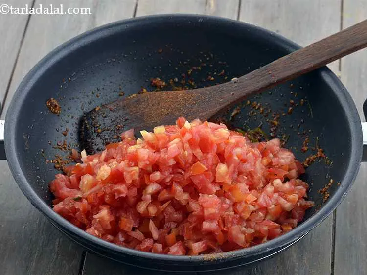 Step 11 – Add the tomatoes. Use the red tomatoes and not the greenish ones.