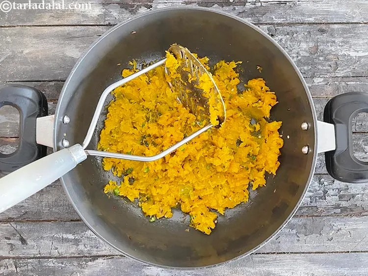 Step 16 – Once cooled, mash the pumpkin pieces with help of a masher.