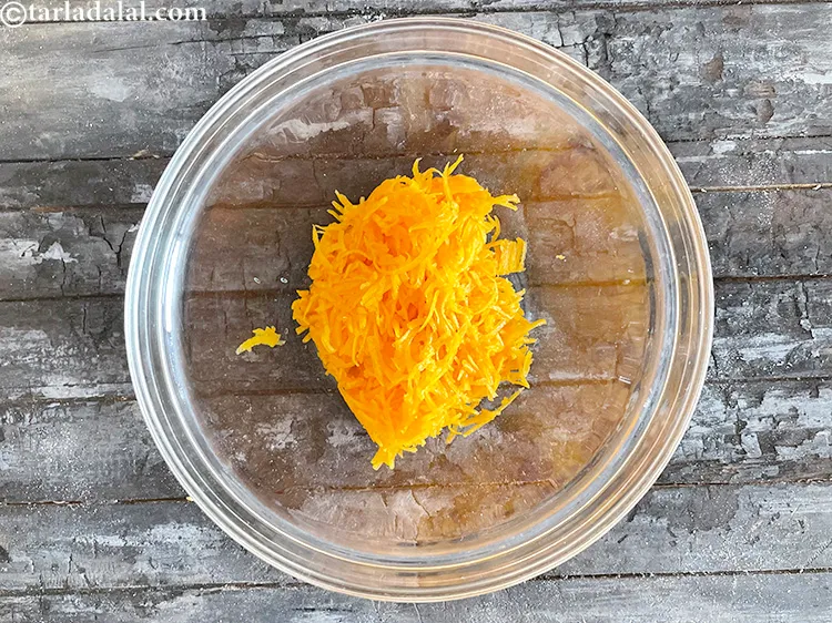 Step 10 – In a deep bowl put&nbsp;<meta charset="UTF-8" />1 cup&nbsp;<a href="glossary-grated-red-pumpkin-1084i">grated red pumpkin</a>&nbsp;(bhopla / kaddu).