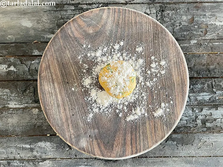 Step 21 – Flatten paratha and pust some flour over it.