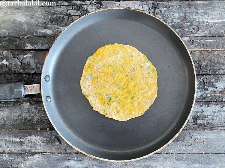 Step 24 – Please the rolled roti on the hot tava.