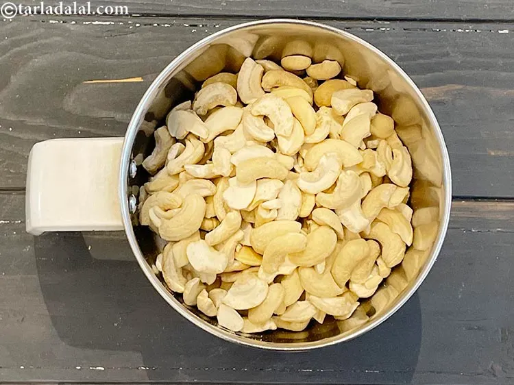 Step 2 – To make kaju barfi, put broken cashewnuts in a mixer.
