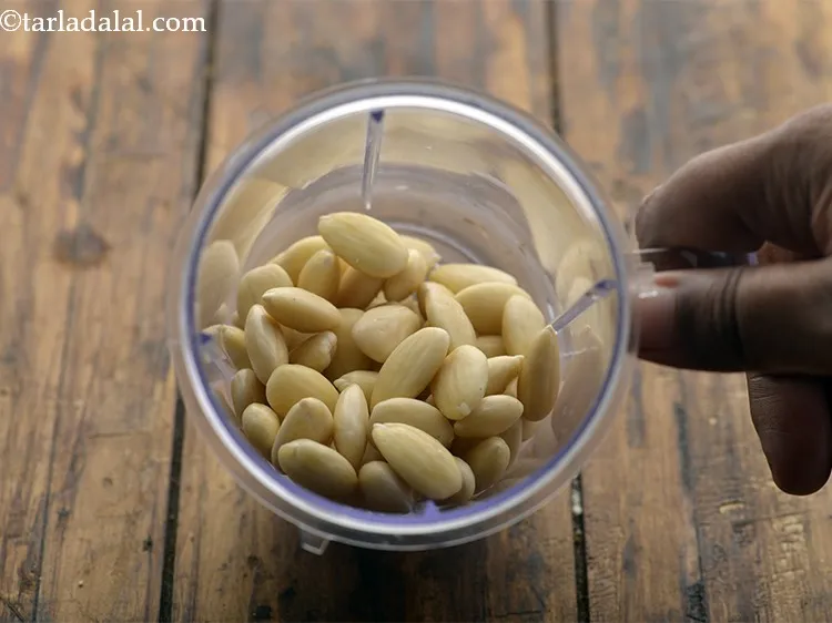 Step 8 – Place these blanched and peeled almonds in a mixer jar.&nbsp;
