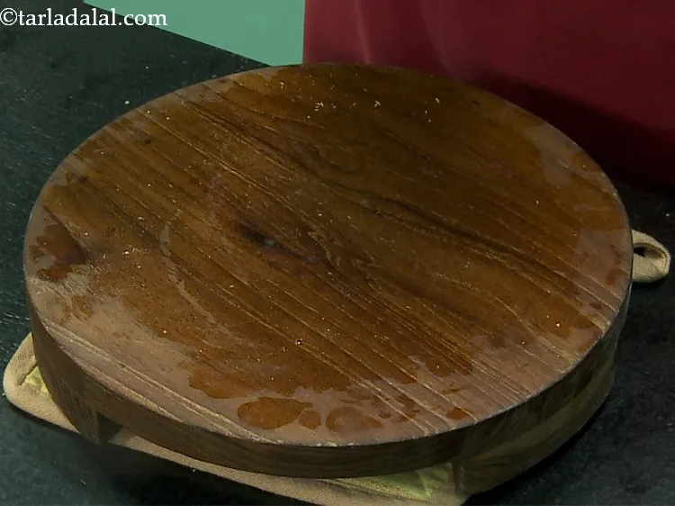 Step 27 – Grease a rolling board with a little butter.&nbsp;