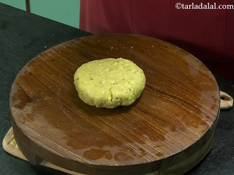 Step 28 – Flatten one portion of the dough and place it on the greased rolling board.