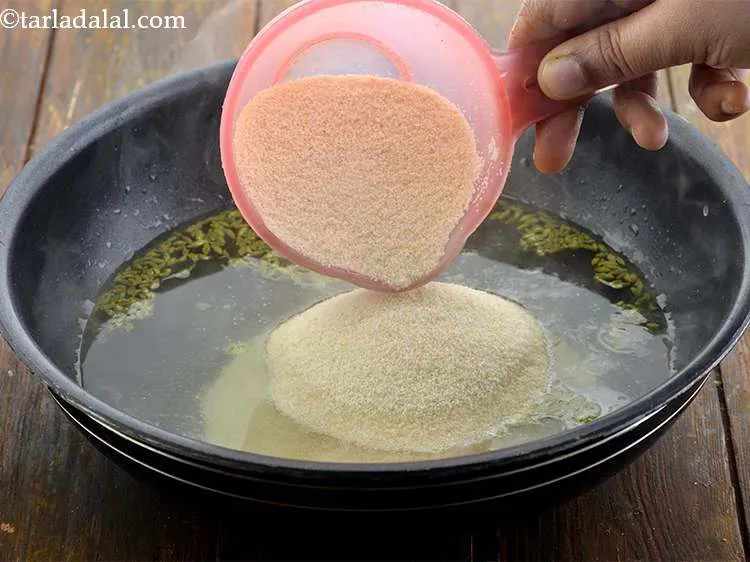 Step 6 – Add the semolina and stir continuously over a medium flame.