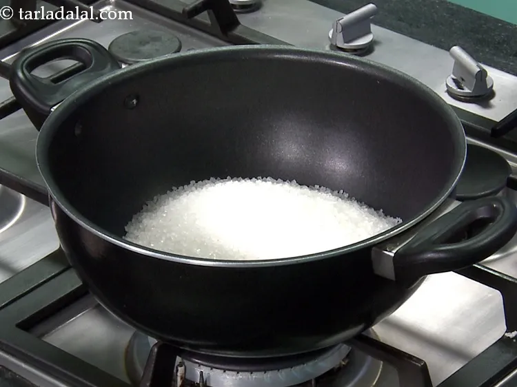 Step 3 – For the sugar syrup, add 3 cups&nbsp;<a href="https://www.tarladalal.com/glossary-sugar-chini-shakkar-278i">sugar</a>&nbsp;in a deep non-stick pan.