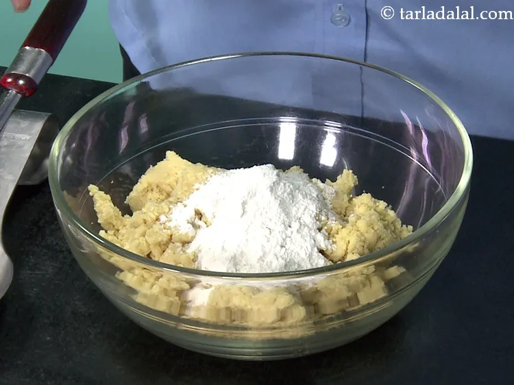 Step 10 – Add 1/4 cup&nbsp;<a href="https://www.tarladalal.com/glossary-plain-flour-maida-188i">plain flour (maida)</a>. This is needed for binding.