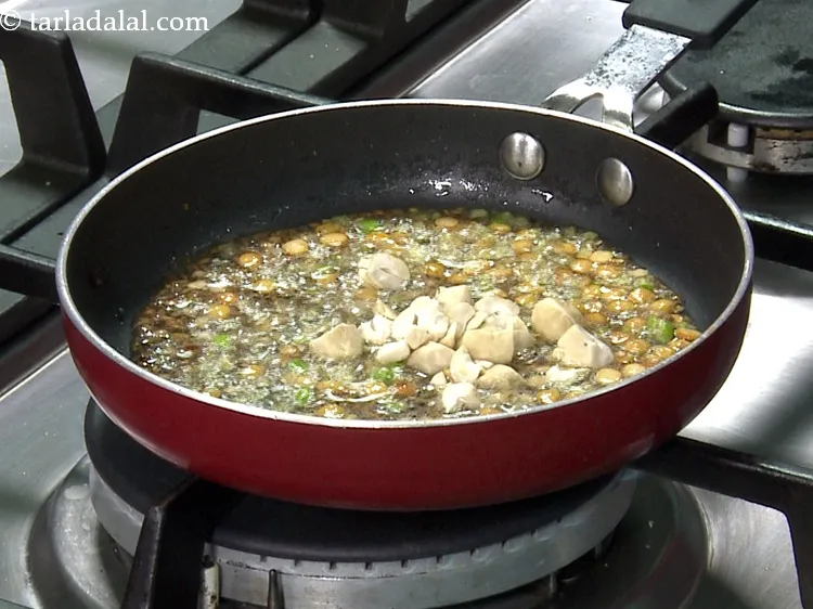 Step 43 – To this add the cashewnuts. Addition of cashews is very unique to this idli. Chop …