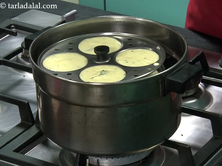 Step 61 – For convenience, this batter is traditionally cooked in small greased katoris or in a large, …