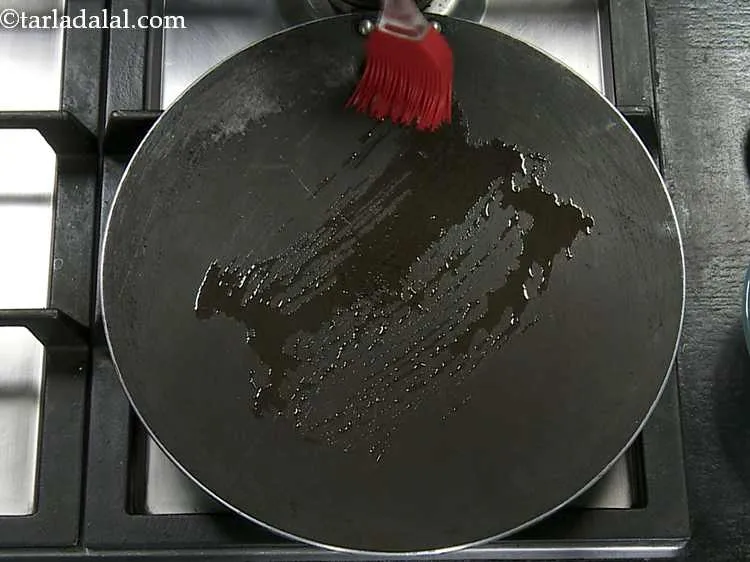 Step 6 – Heat a non-stick tava (griddle) and grease it with a little ghee.