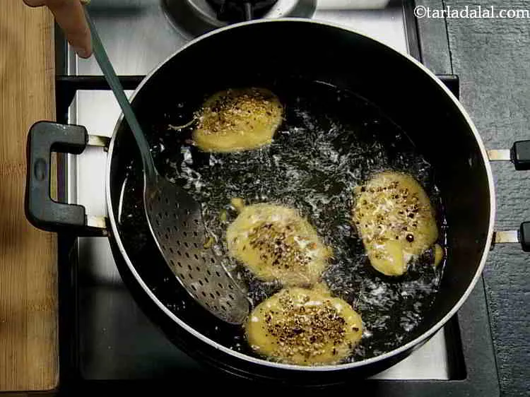 Step 14 – Deep-fry a few slices at a time till they turn golden brown in colour from …