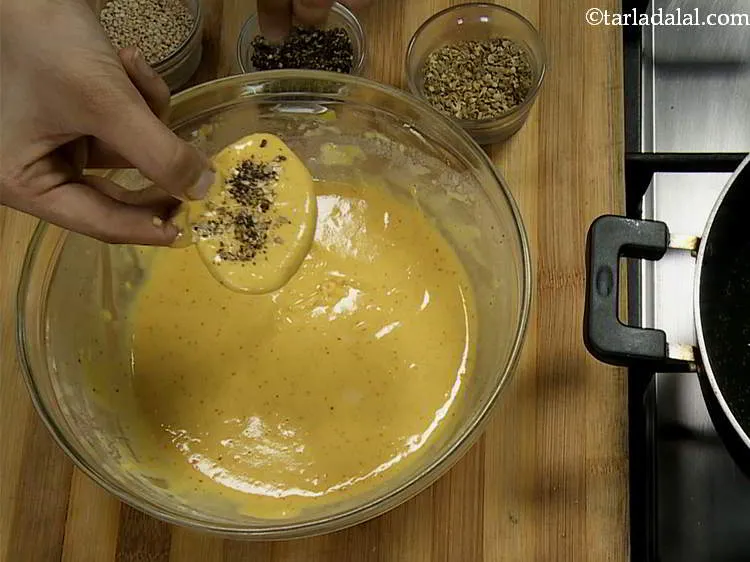Step 13 – Finally sprinkle some sesame seeds on top of the batter-coated yam slices. While you are …