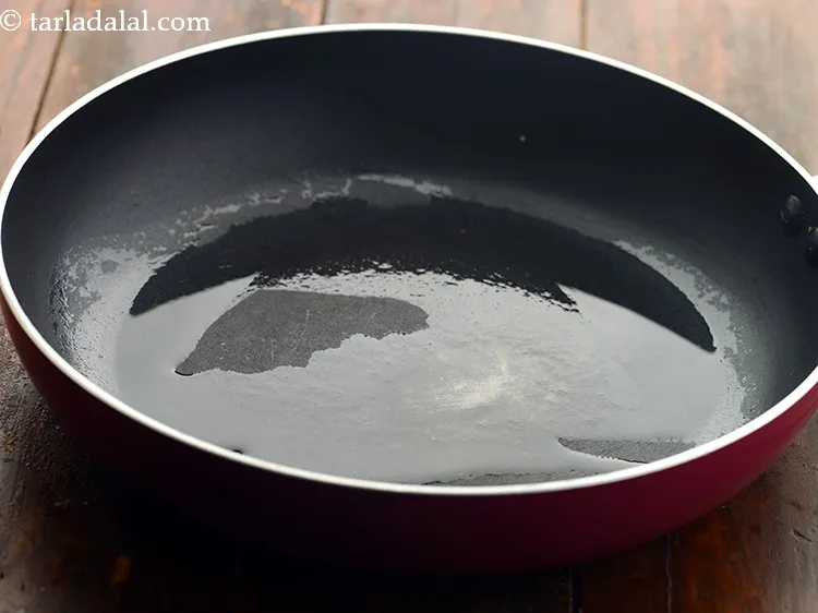 Step 5 – Heat 2 tbsp&nbsp;<a href="https://www.tarladalal.com/glossary-oil-671i">oil</a> in a broad non-stick pan.
