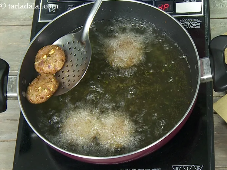 Step 21 – Deep fry on a medium flame, till they turn golden brown in colour from all …