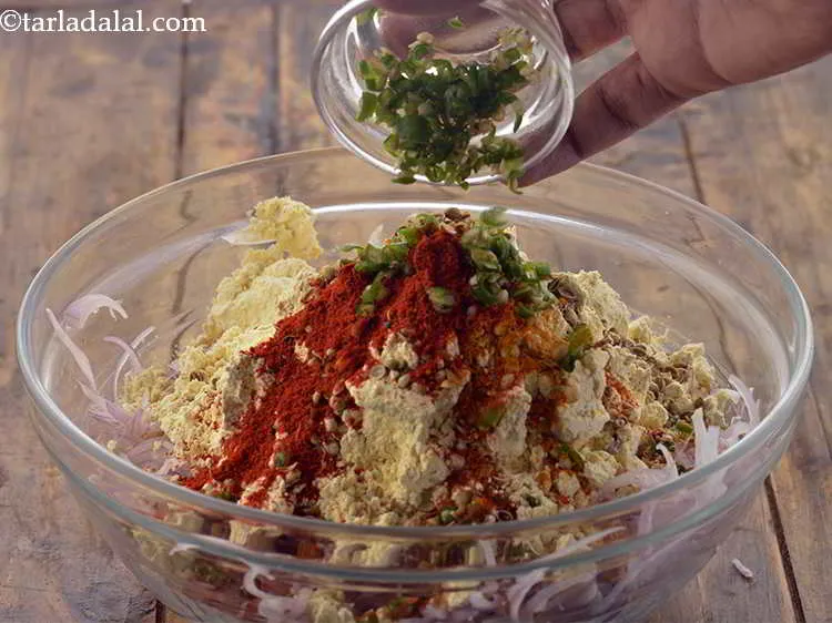 Step 11 – Add green chillies for spiciness, you can add more if you like your <strong>Kanda Bhaji</strong> …