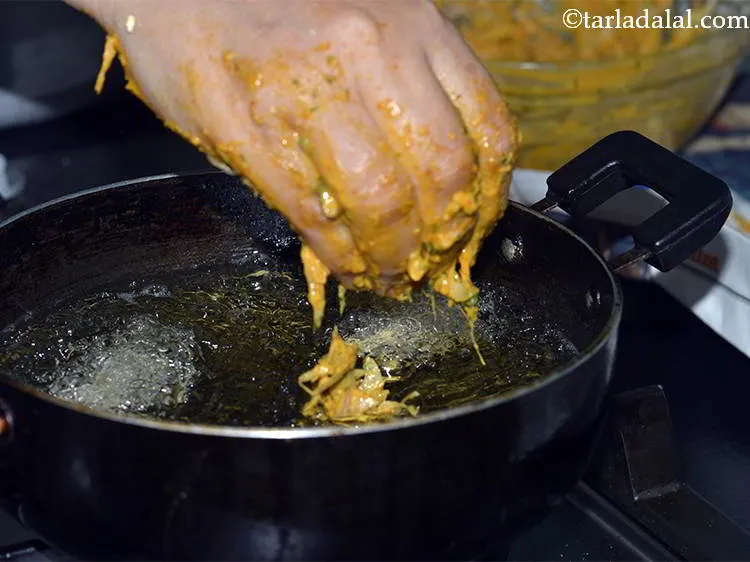 Step 17 – Drop spoonfuls of the onion mixture using your fingers. Do not fry them over low …