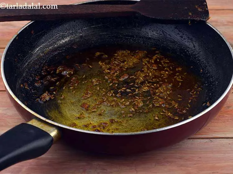 Step 28 – In the same pan, add the cumin seeds. They will impart and earthy flavour into …