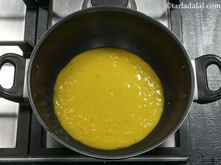 Step 16 – Transfer the whisked dal into a deep non-stick pan for cooking.