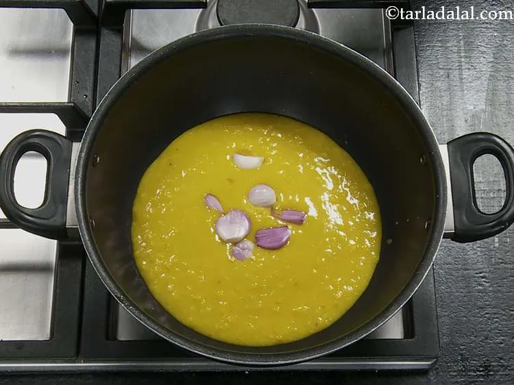 Step 17 – To it, first add the shallots. These are also called sambar onions.
